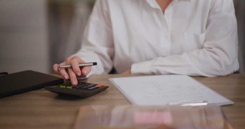 Businesswoman calculating expenses for startup accounting