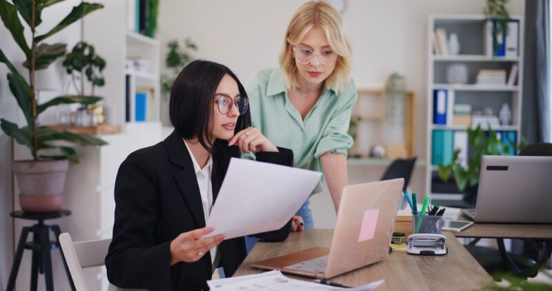 Colleagues collaborating on a business plan at a startup office