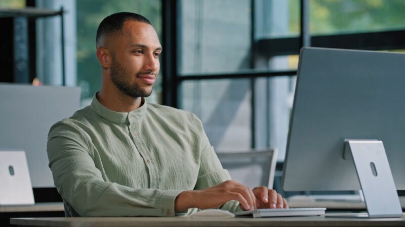 Entrepreneur researching how to start a business in Delaware in a modern workspace