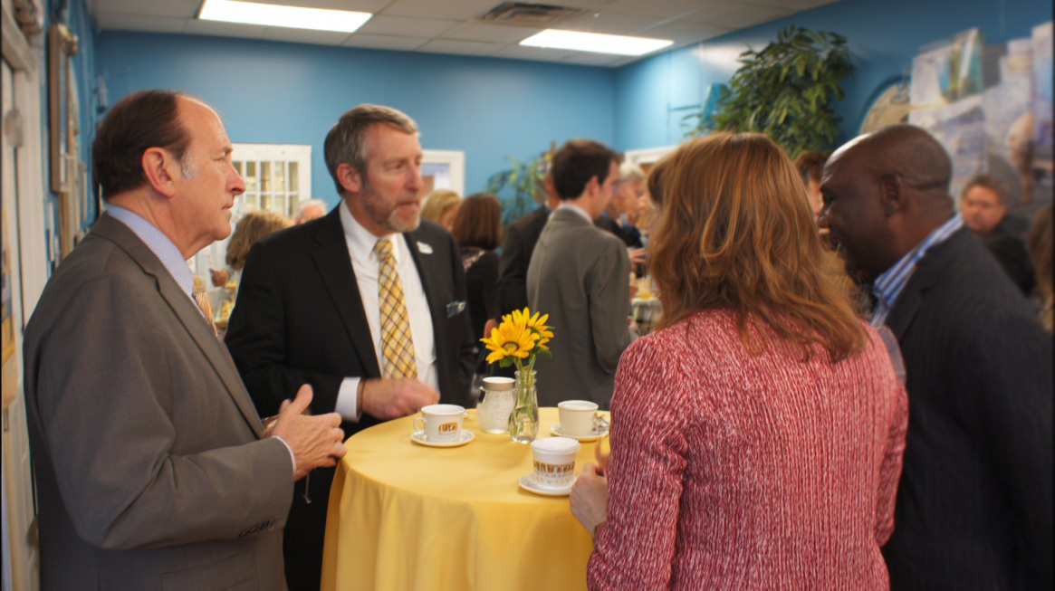 Professionals gathered around a table, networking at the Delaware Business Expo
