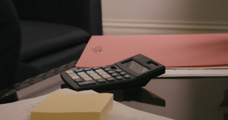 Close-up of financial documents and calculator during cost assessment for incorporation
